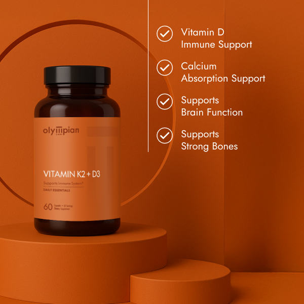 Olympian Vitamin K2+D3 supplement bottle on an orange background with benefits listed.
