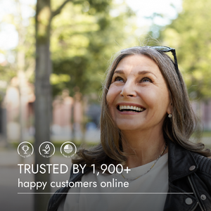 Woman smiling outdoors with a blurred background