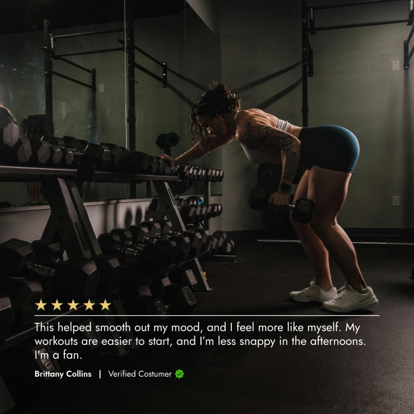 Person exercising with dumbbells in a gym setting