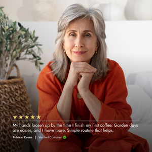 Woman in an orange sweater sitting on a couch with a plant in the background